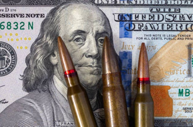 Background with American dollars and bullets from a machine gun. Global world crisis and world war