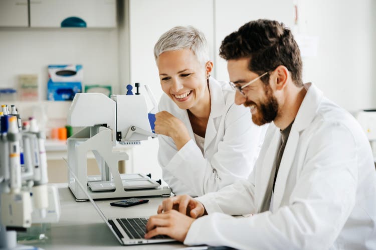 Two Scientists Sharing Moment of Laughter in the Laboratory