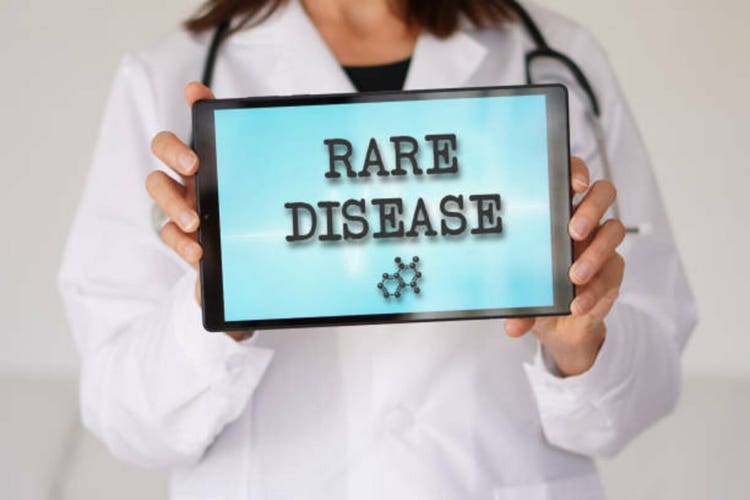 Rare disease. health problem. woman doctor showing words written on a tablet.