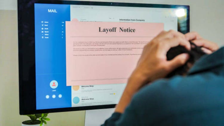 Frustrated fired man reading bad news in pink slip e-mail letter from laptop at home, Company got serious financial problems because economic recession,corporate downsizing ,she was laid off quitting job Unemployment concept