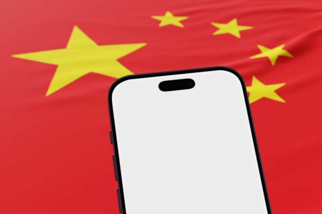 Mobile phone showing a white blank screen in front of the national flag of China. Illustration of the concept of Chinese mobile app and online service platforms