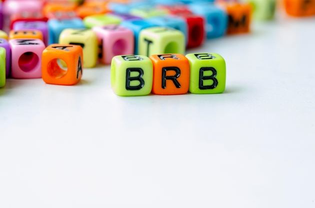 BRB text on colorful plastic alphabet beads representing Be Right Back. Taking a break concept