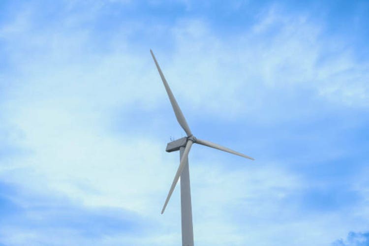 Wind farm on the mountain. Lonely windmill on a beautiful sunny day. Wind energy concept, alternative energy, renewable energy