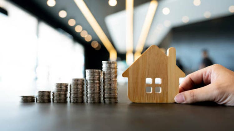 Wood house and row of coin money on wood table and , selective focus, Planning to buy property. Choose what"s the best. A symbol for construction ,ecology, loan concepts.