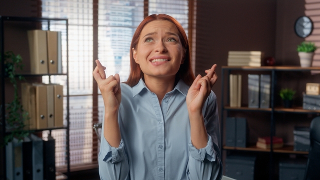 Hopeful Caucasian business woman girl female businesswoman employer company worker in office close eyes crossed fingers hope wish superstitious gesture wishing luck want to win waiting good news pray