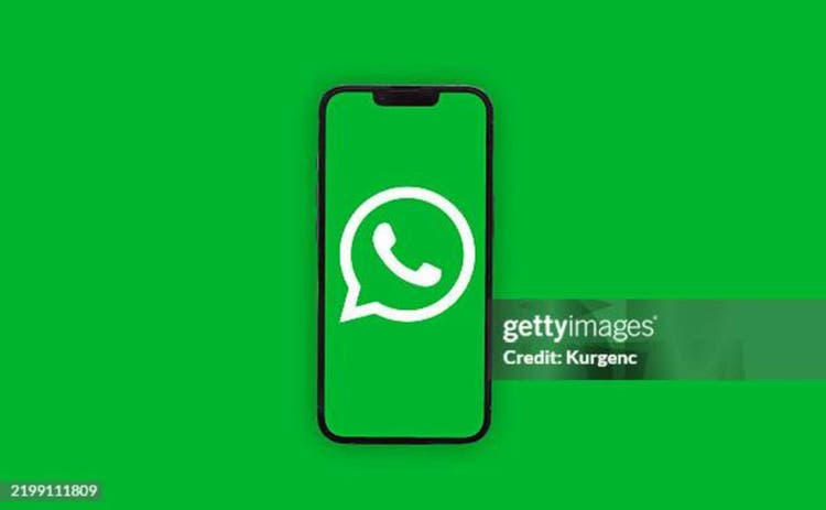 WHATSAPP app icon on smartphone screen over green background. ADANA-TURKEY - FEBRUARY-26-2025