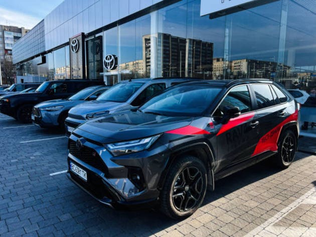 Modern Toyota SUV vehicles parked outside a dealership on a sunny day