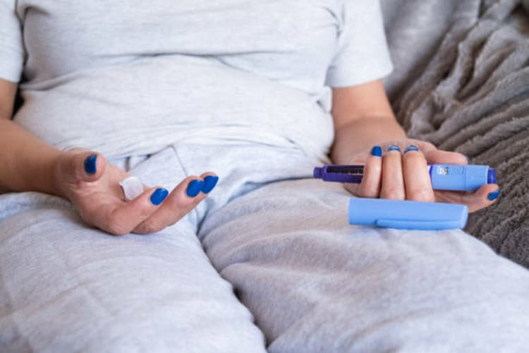 unrecognizable overweight mature woman holding in her hand a syringe of semaglutide injectable medication for medical treatment of obesity
