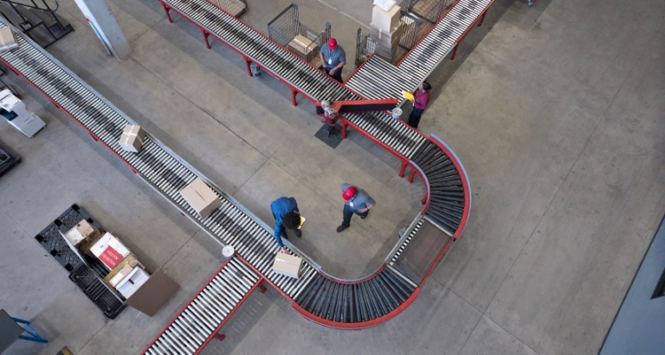 Male and female worker working at conveyor belt
