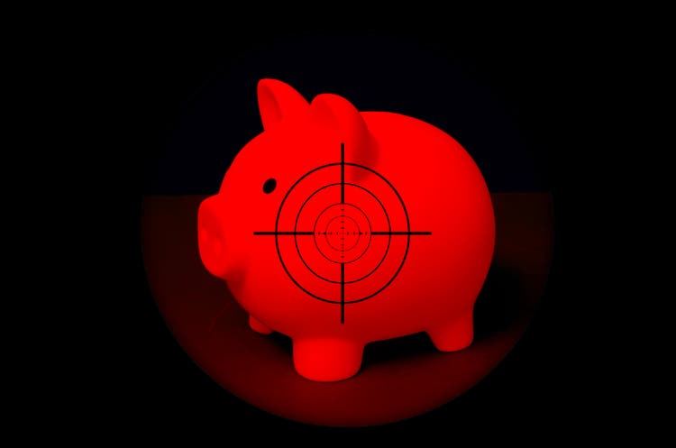 Savings in danger - Piggy bank in the crosshairs
