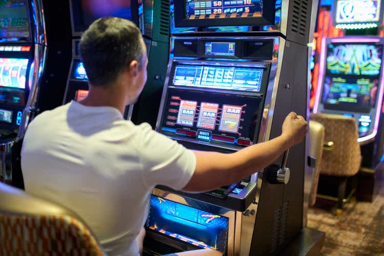 Man Playing Slot Machine