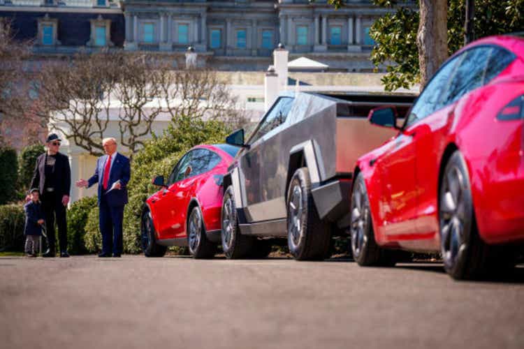 President Trump speaks alongside Tesla vehicles in the White House