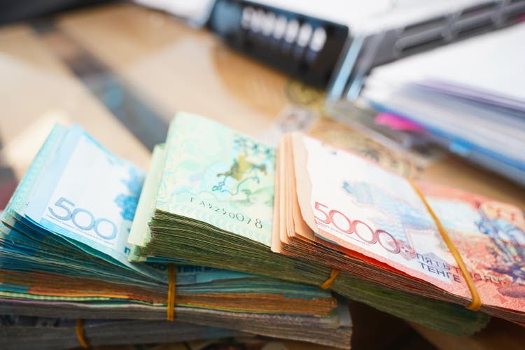 Stacks of Kazakhstani tenge of different denominations.
