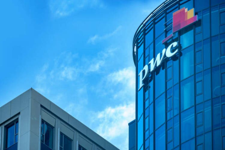 PwC logo on glass facade, high-rise glass office building against blue sky, finance and consulting, global economy, professional financial services in Germany, Frankfurt - February 9, 2025