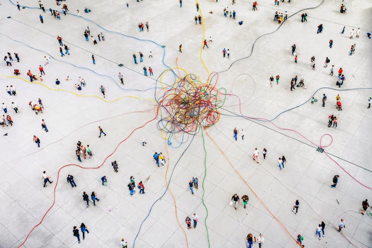Aerial view of crowd connected by colouful lines