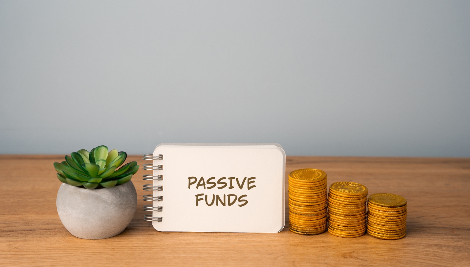 Passive funds concept. Investment funds that aim to replicate the performance of a specific market index rather than actively selecting individual securities. Notes and coins. Business
