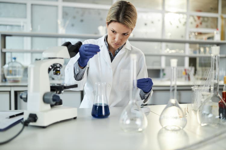 Female scientist working on medial research in laboratory.