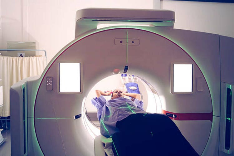 Young female Undergoing Medical Imaging Procedure Using Advanced Equipment CT simulator in a Hospital