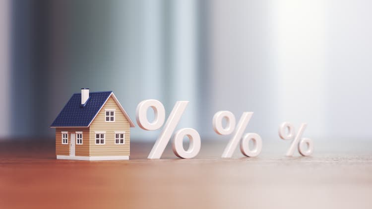 Miniature house Real Estate Trading and Percentage Signs, Mortgage Low and High Interest Concept Buying and Selling