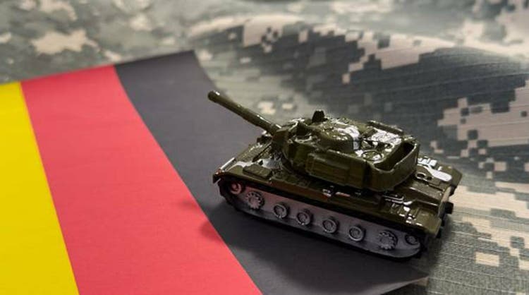 War, military threat, military power concept. Germany. Tanks toy near German flag on black background top view