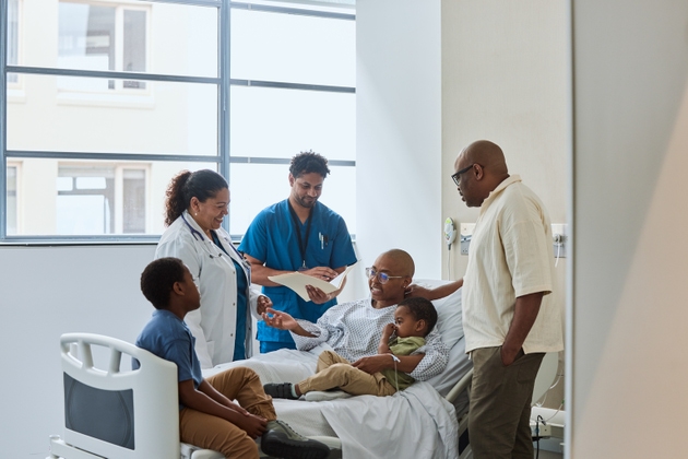 Female cancer patient talking with medical staff