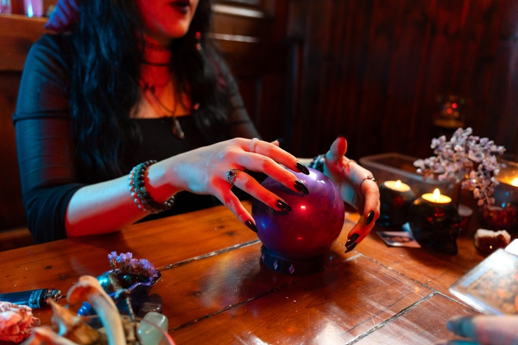 Fortune teller predicting future using crystal ball in a mystical atmosphere