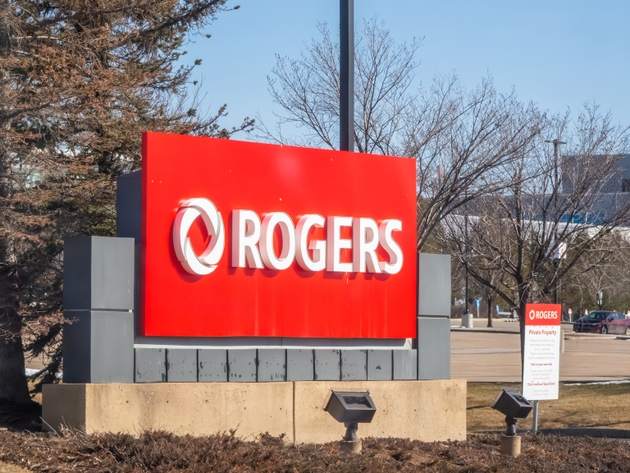 A large red ROGERS sign stands outdoors under a blue sky, indicating Rogers Communications property. Another sign reads Private Property.