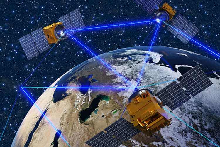 Satellites surrounding the planet Earth and sending blue laser beams to each other for communication. Illustration of the concept of telecommunication and satellite mobile phone network