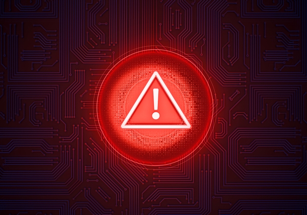 Warning Sign of digital risk: A luminous red warning sign in the shape of a circle with an exclamation mark centered, stands out against a dark tech background
