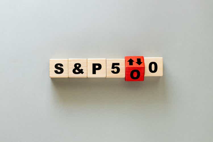 S and P 500 index symbol. Wooden blocks with an arrows that symbolizes that the S and P 500 index is changing trend, goes up or down. Business concept. Flat lay, gray background
