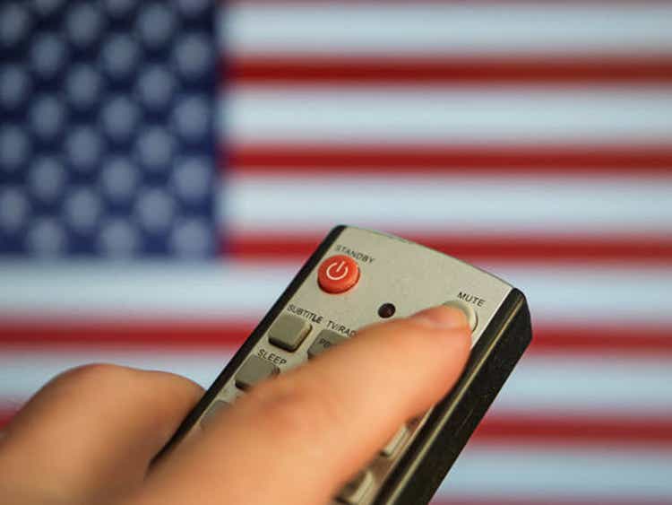 Remote Control with Mute Button Against American Flag Background