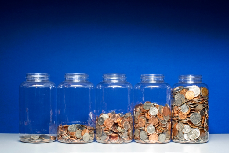Savings growth concept - 5 jars of coins ascending