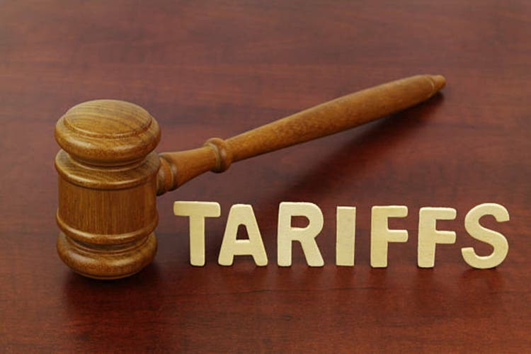 Word tariffs and judge gavel close-up.