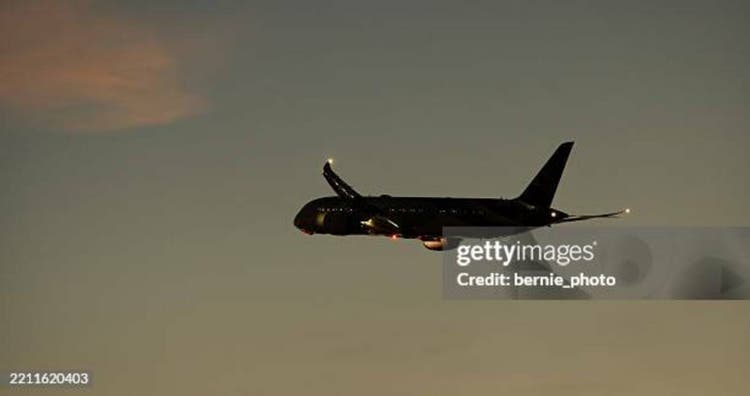 Silhouette of airplane take off at sunset