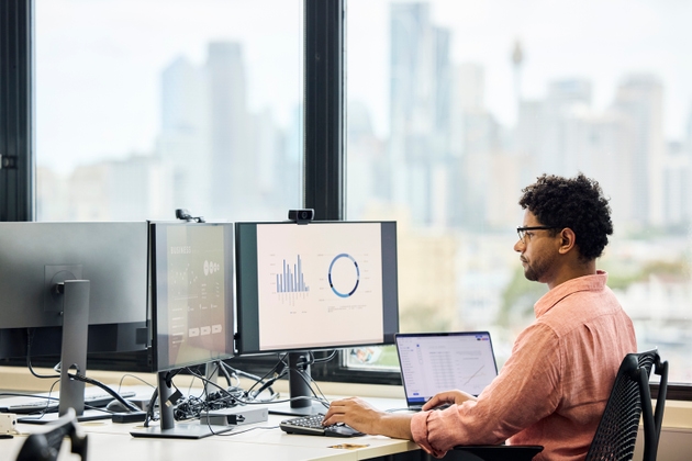 Male business expert going through sales data