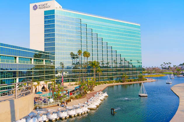 Hyatt Regency Hotel Overlooking Marina And Lush Palm Trees In Long Beach, CA