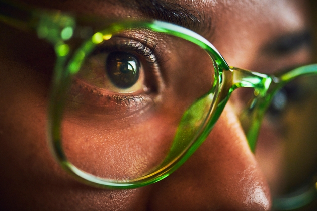 Focused Woman Wearing Green Glasses Late at Night