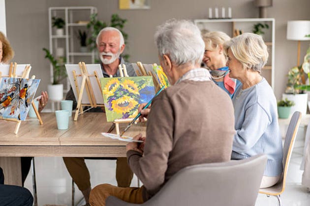 A group of seniors engaging in a creative painting class