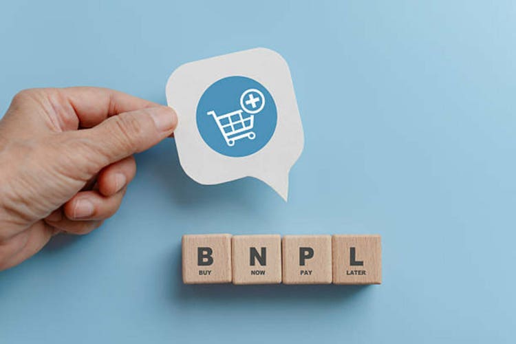 BNPL, now buy the payment later, on the wooden cube blocks and paper white paper