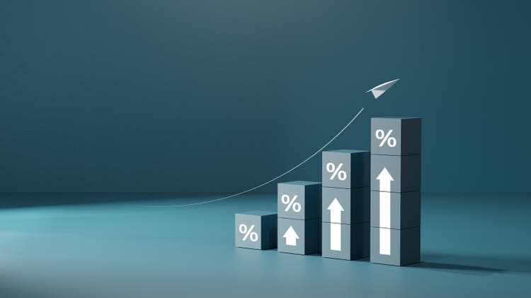 Wooden blocks with percentage signs showing an upward trend, concept of interest growth.