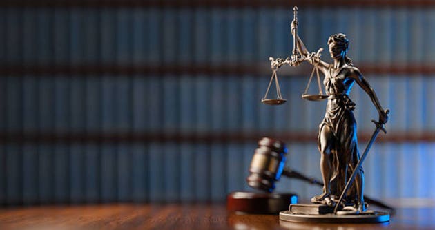 Legal Concept: Themis is the goddess of justice and the judge"s gavel hammer as a symbol of law and order on the background of books
