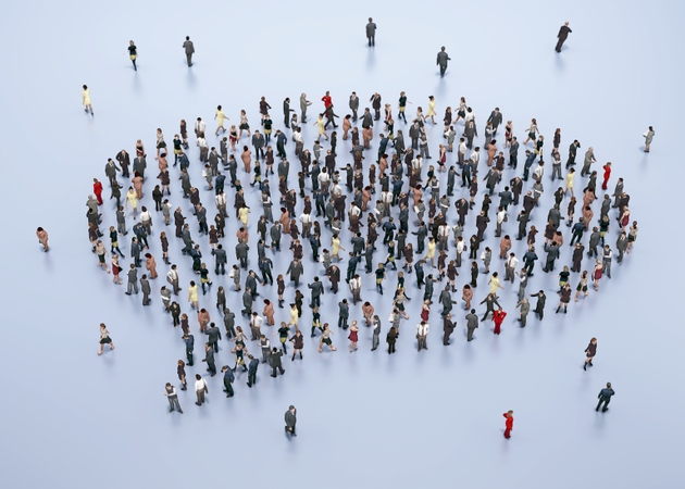 Crowd of diverse individuals gathered in a creative arrangement during a public event in an urban setting