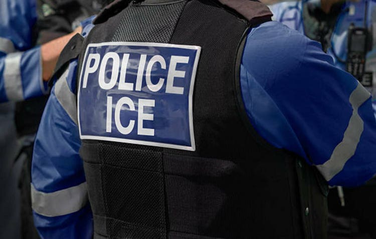 Ice Police agents - Immigration and Customs Enforcement. Close-up of POLICE ICE marking on the back of worn by a trio of DHS police officers at the scene of an incident.