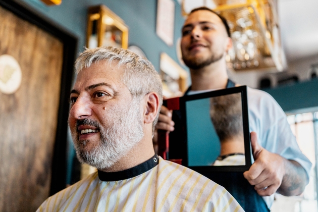 Mature man smiling after haircut at barbershop