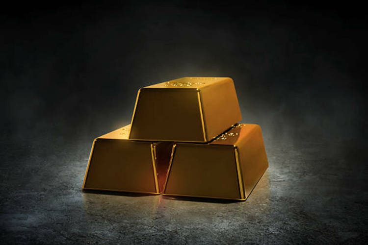 Stack of shiny gold bars on dark background