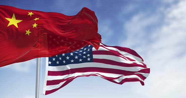 Chinese and American flags waving together against blue sky. 3D render
