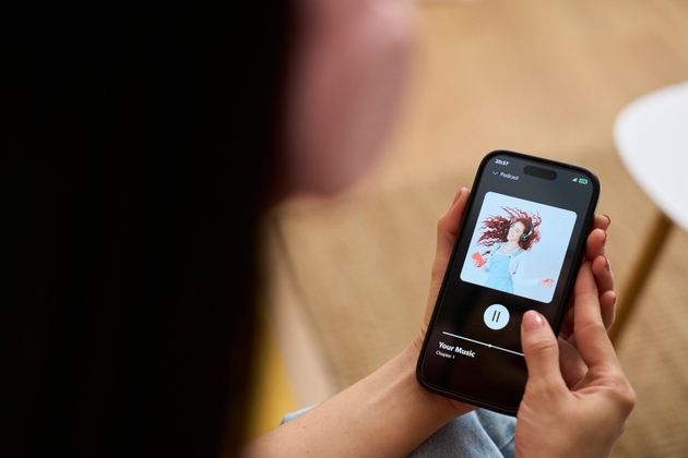 Woman relaxing at home listening to music on mobile app