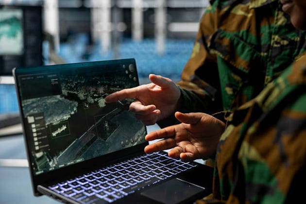 Close up of army experts in data center analyzing infrared surveillance feed