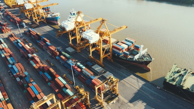 aerial view of singapore container port with cargo shipping vessels and cranes at singapore harbor captured from above with industrial dock activity