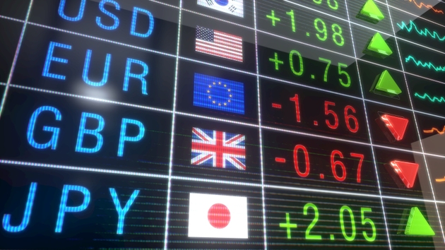 Various exchange rates on flowing digital screen fluctuate in financial market update